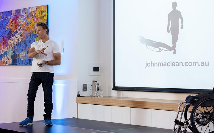 Man speaking on stage at event